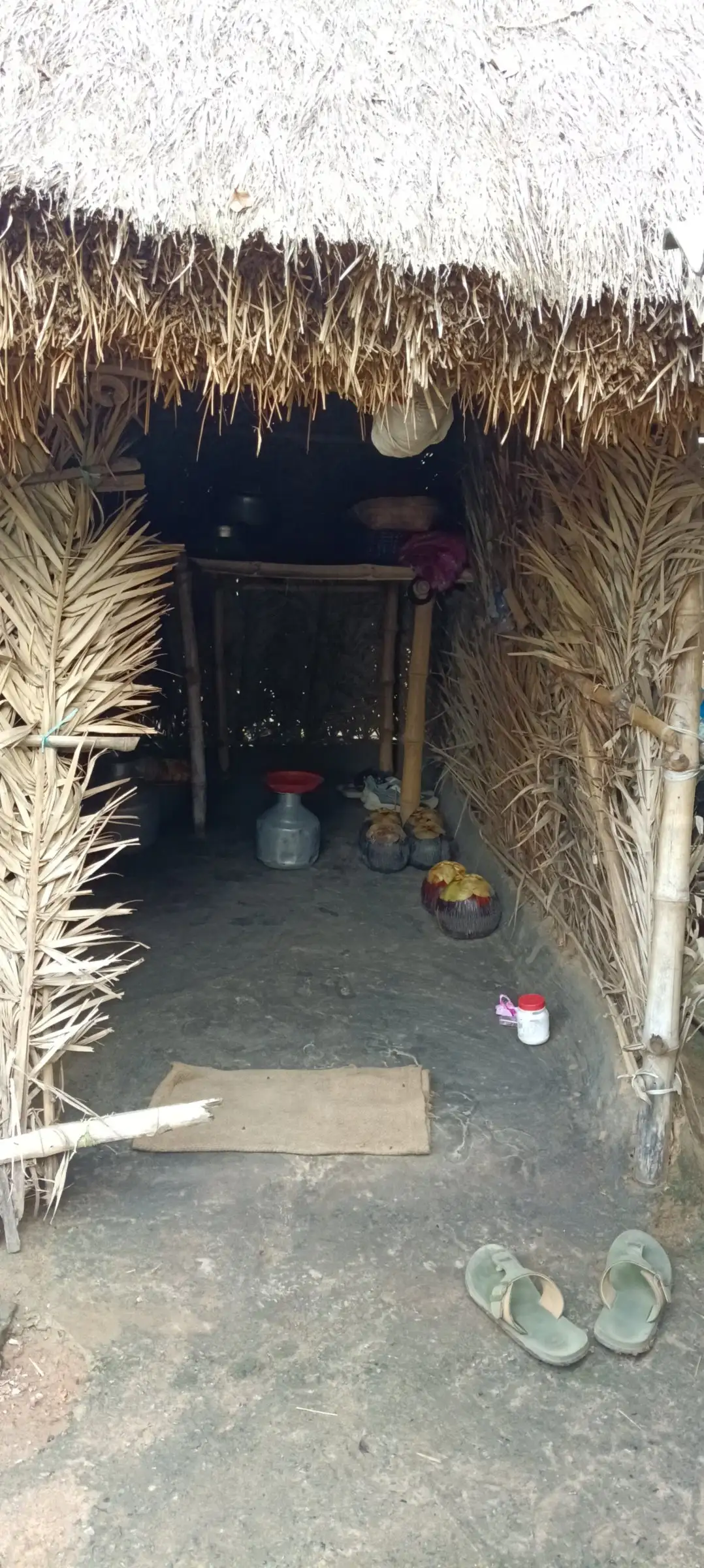 Looking into a thatched hut through its doorway