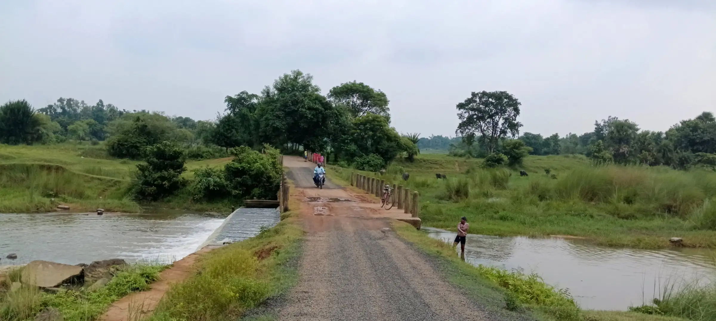 Dirt road crossing a river on a low causeway