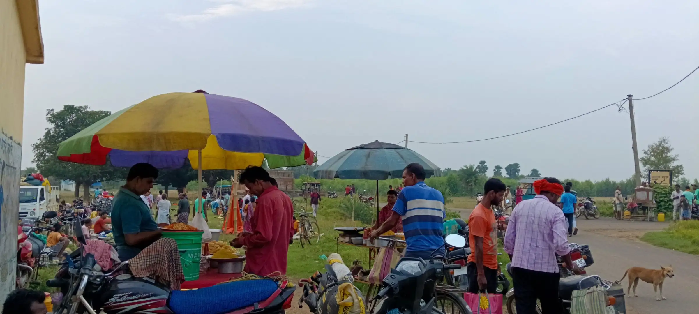 Busy roadside stalls under bright umbrellas