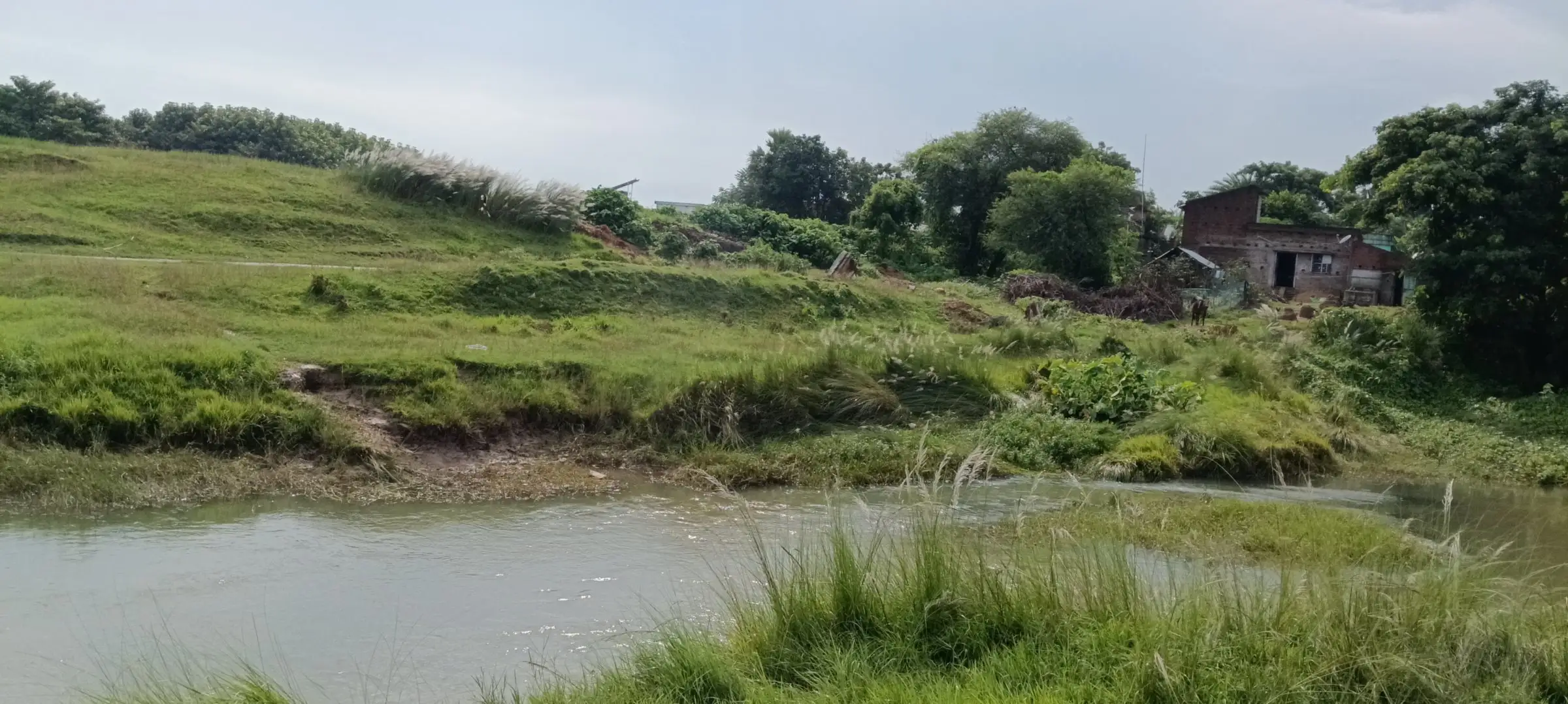 Stream with an old ruined house on the far bank