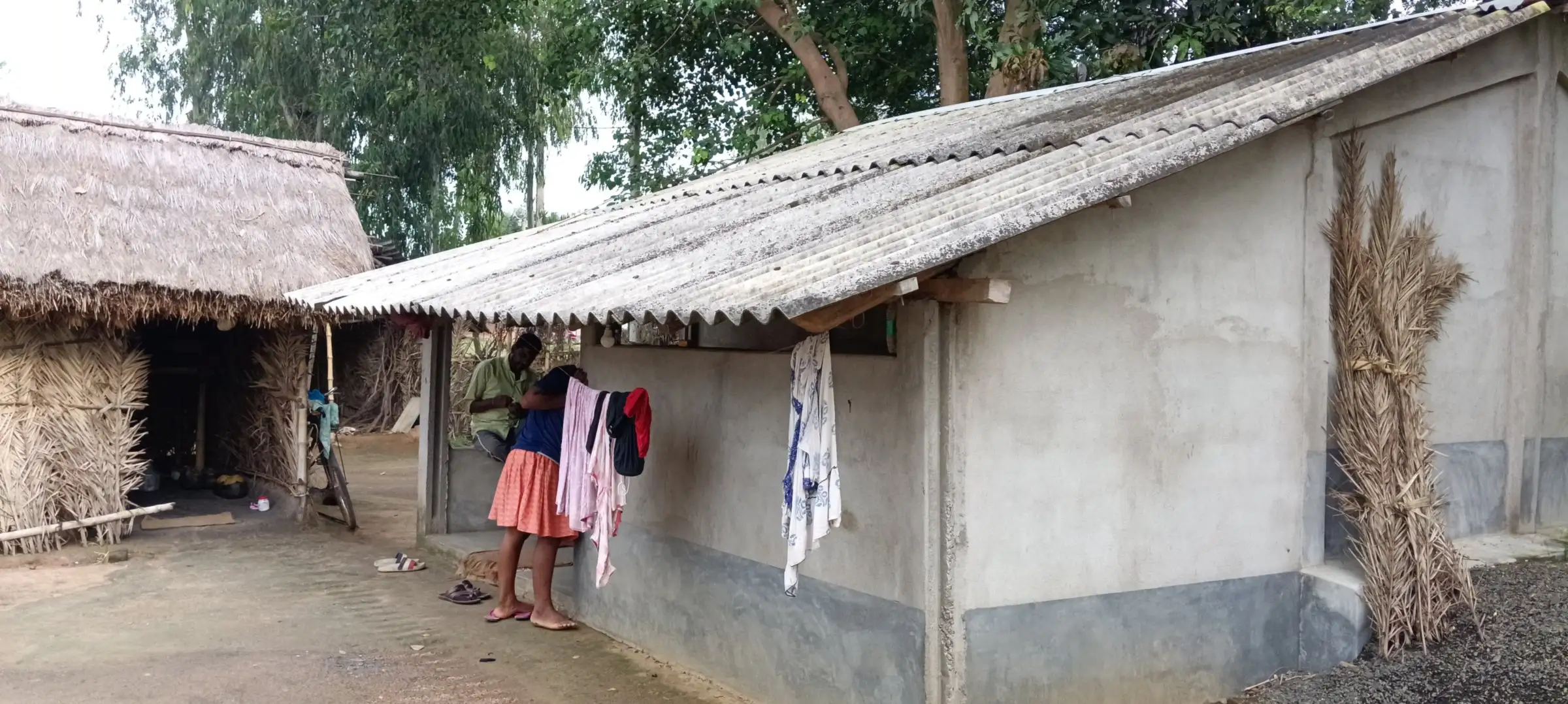 Thatch and tin-roof village homes with laundry drying