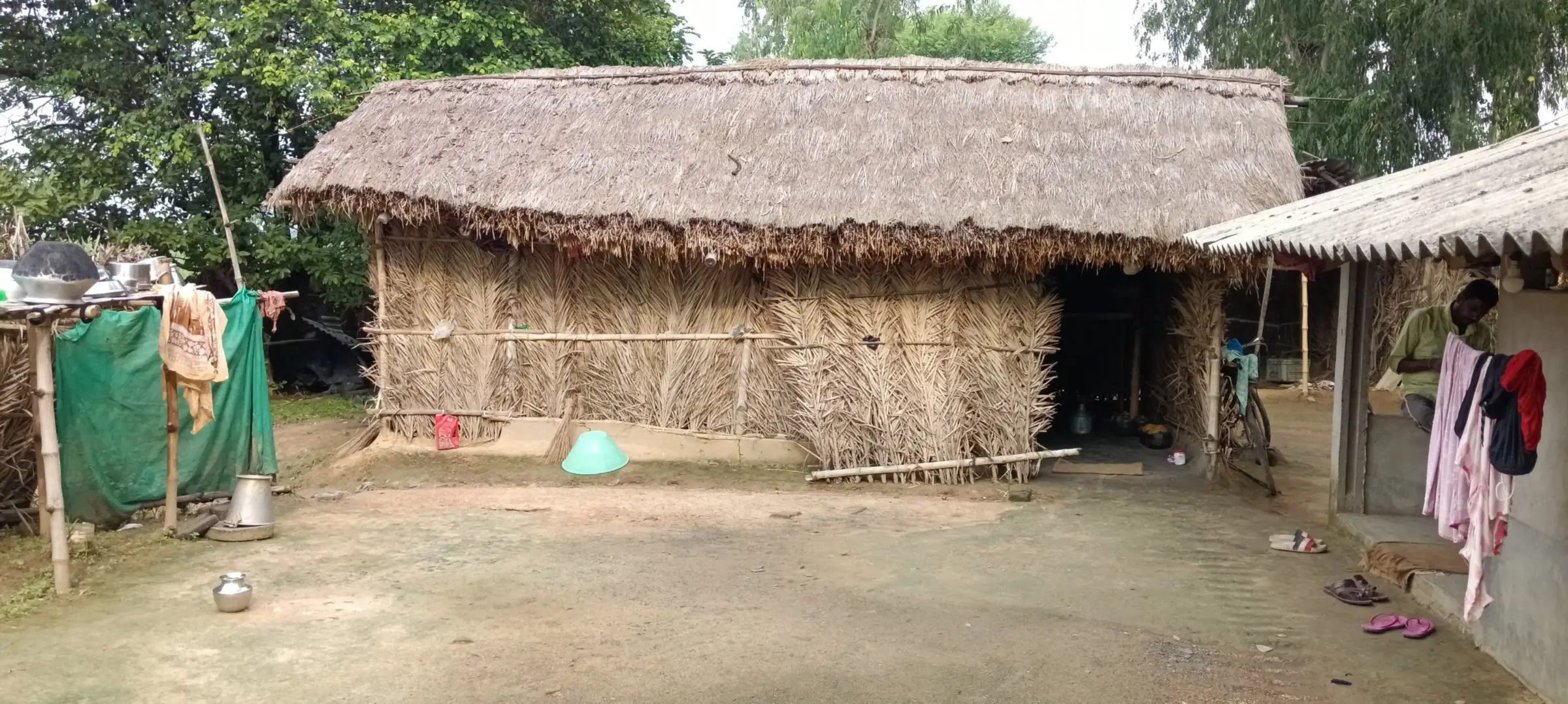 Thatched-roof homes around an open earthen courtyard