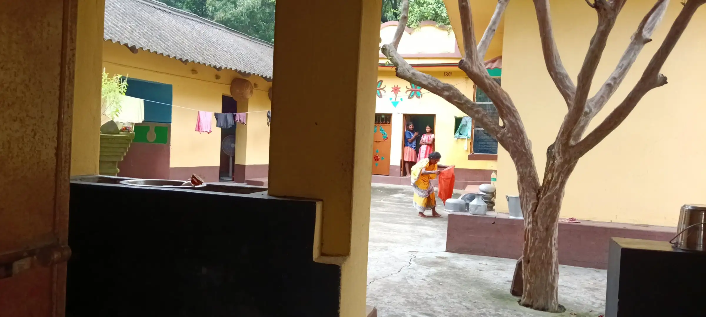 View through veranda pillars into a homestead courtyard